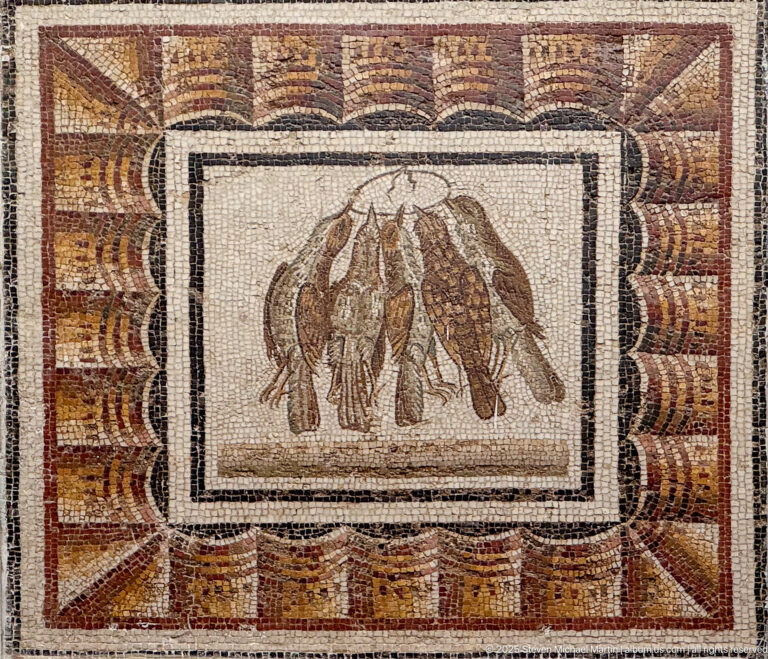 Several dead or suspended game birds clustered in a framed Roman mosaic still life with broad red-brown border.