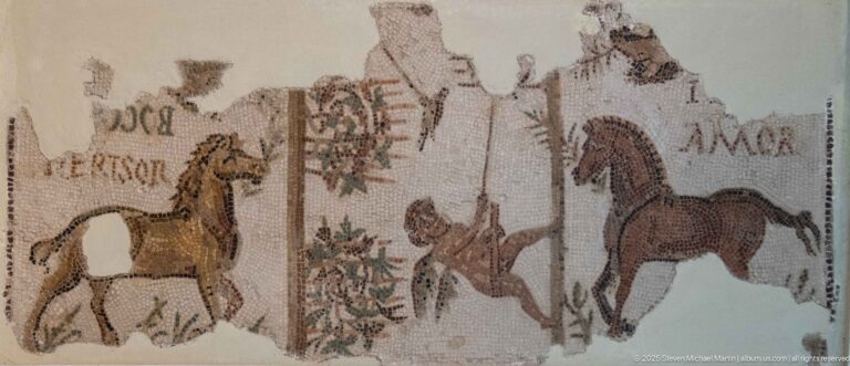 Fragmentary Roman mosaic with two horses, nearby human figures, and partially preserved Latin inscriptions across a damaged field.