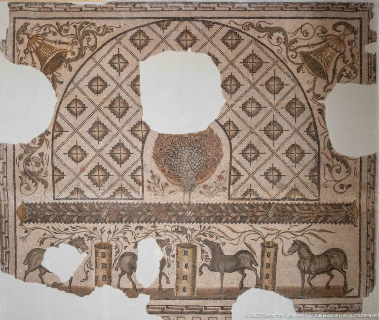 Fragmentary Roman mosaic with central peacock, diamond grid, large corner animals, and a lower animal register.