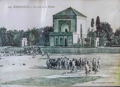 Historic postcard view of the Menara pavilion beside its reflecting basin and gardens in Marrakech.