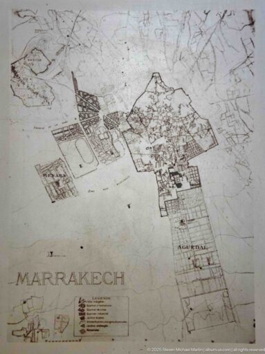 Faded historic map of Marrakech showing the walled city, surrounding roads, compounds, and open land.