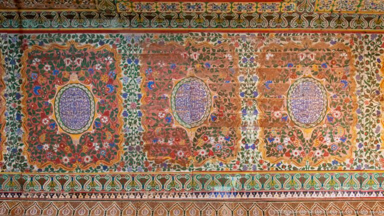Bahia Palace painted frieze with floral panels, oval central medallions and dense red-green-blue ornament.