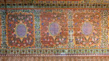 Bahia Palace painted frieze with floral panels, oval central medallions and dense red-green-blue ornament.