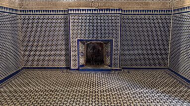 Bahia Palace room covered in black-and-white geometric tilework with a small mosaic-framed wall recess.