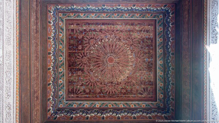 Square Bahia Palace painted ceiling panel with large radiating floral medallion and layered turquoise-red borders.