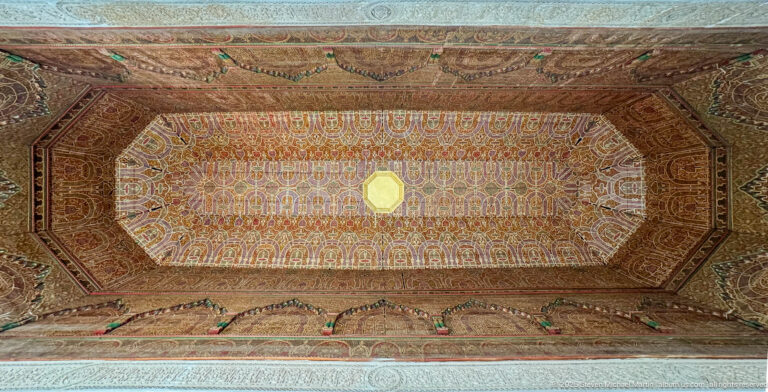 Recessed octagonal Bahia Palace ceiling with repeated painted arch motifs, layered borders and central light.