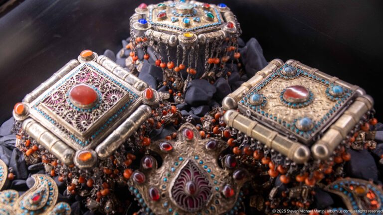 Square silver-toned boxes with filigree, coral-colored cabochons, turquoise accents, and orange bead fringes.