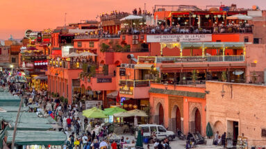 Multi-level Café-Restaurant de la Place with rooftop diners above crowded Djemaa El Fna.