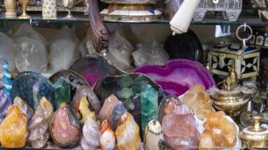 Polished stone points, agate slices, and crystal clusters arranged in a market display.