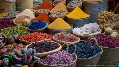 Baskets and bowls filled with dried flowers, herbs, spices, seeds, and pale mineral-like chunks.