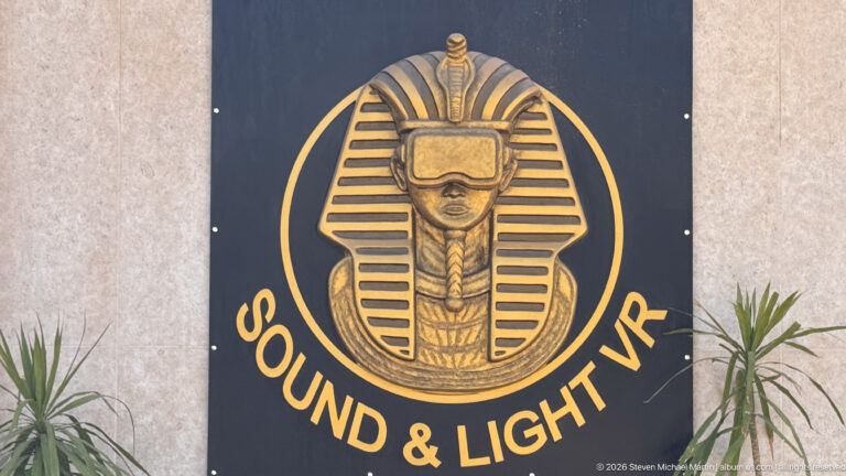 Black and gold “Sound & Light VR” sign with a stylized pharaoh mask wearing virtual-reality goggles.