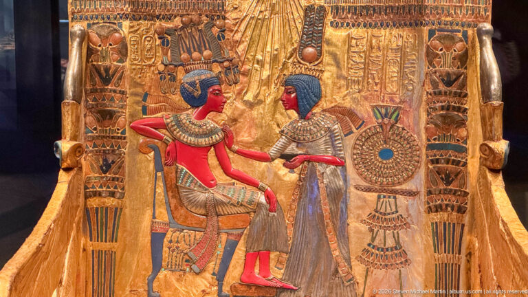 Backrest of Tutankhamun’s Golden Throne showing the seated king and Queen Ankhesenamun beneath rays of the Aten.