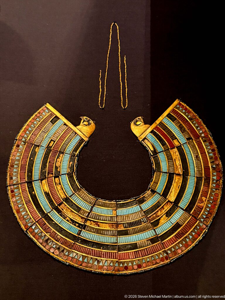 Semicircular multicolored broad collar with rows of inlay and small falcon heads at both upper ends.