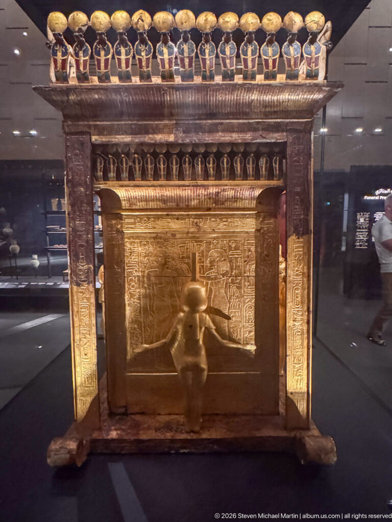 Front of Tutankhamun’s gilded Canopic Shrine on a Sledge with a standing goddess and cobra frieze.