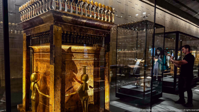 Oblique view of Tutankhamun’s gilded Canopic Shrine on a Sledge with cobra friezes and guardian goddesses.
