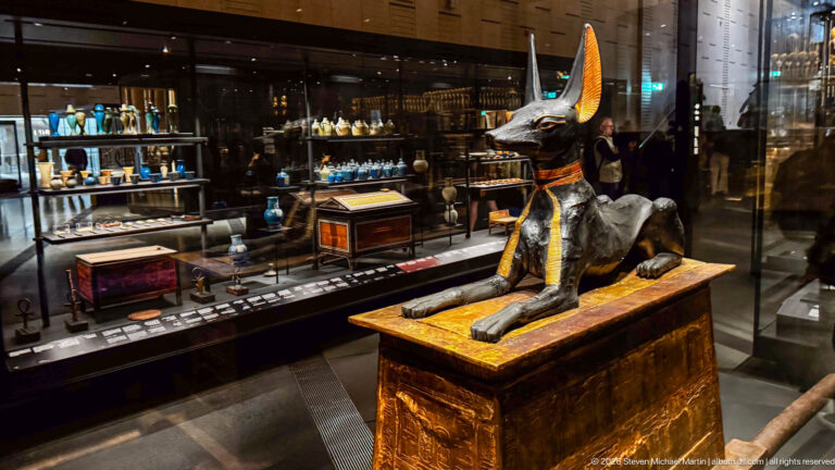 Black jackal-form Anubis reclining on a gilded pylon-shaped carrying chest and sledge from Tutankhamun’s tomb.