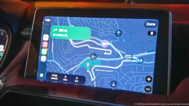 Car navigation screen displaying a route through Amman with turn arrows, street labels, and a short distance instruction.