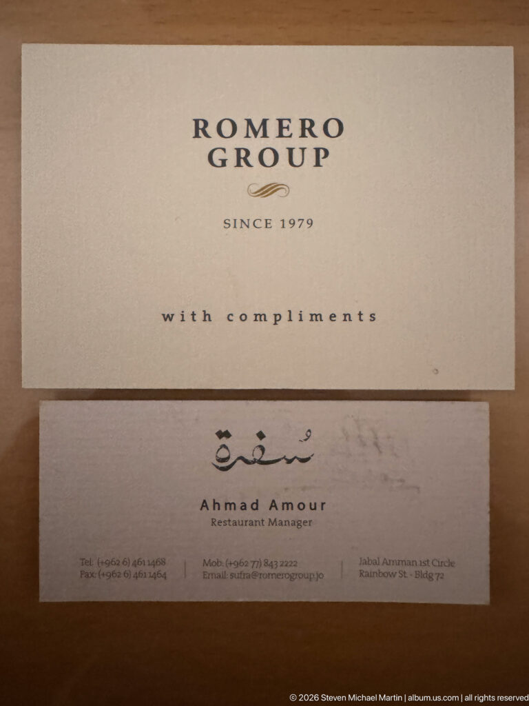 Romero Group card above a business card naming restaurant manager Ahmad Amour in Amman.