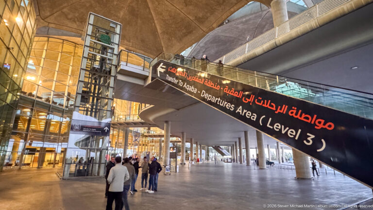 Arabic-and-English sign points to the Level 3 departures area inside Queen Alia International Airport.