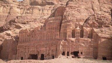 Panoramic view of Petra’s Royal Tombs carved across the sandstone cliff of Jabal al-Khubtha above the city center.