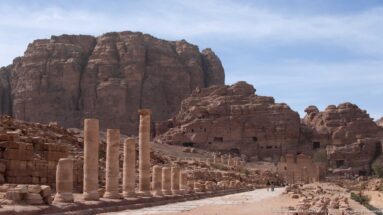 Long view along Petra’s Colonnaded Street with surviving columns and the paved ancient roadway through central ruins.