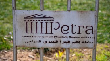 Metal Petra Development and Tourism Region Authority sign with Petra logo and Arabic-English text.