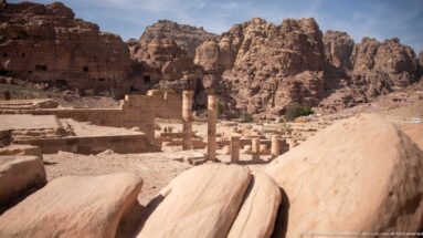 Standing columns, fallen stone blocks, and excavated walls in the lower precinct of Petra’s Great Temple.