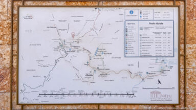 Petra trails guide showing site map, walking routes, landmarks, trail legend, and estimated hiking times.