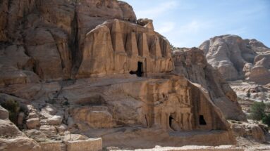 Obelisk Tomb complex near Bab as-Siq with tall carved obelisks above rock-cut chambers in the sandstone cliff.
