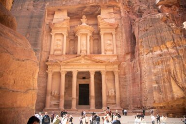 Visitors gathered below the full rock-cut façade of Al-Khazneh, Petra’s Treasury, at the end of the Siq.