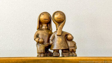Close view of stylized bronze adults and children in Tom Otterness’s Other Worlds at Hamad International Airport.