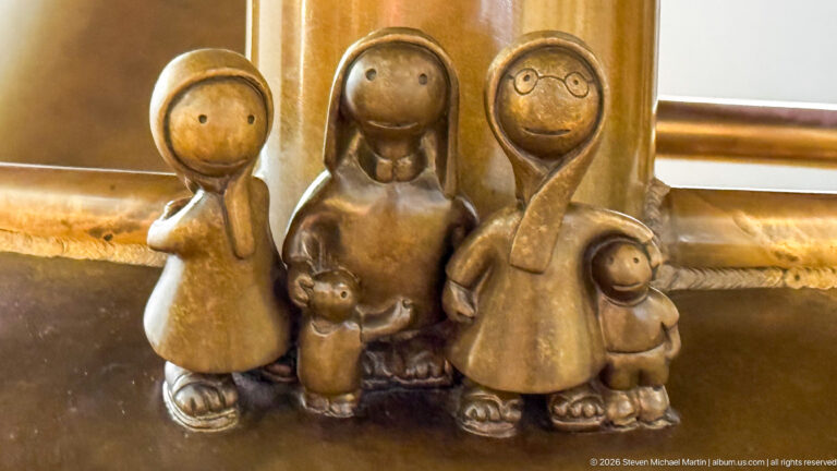 Small group of stylized bronze adult and child figures in Tom Otterness’s Other Worlds at Hamad International Airport.