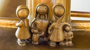 Small group of stylized bronze adult and child figures in Tom Otterness’s Other Worlds at Hamad International Airport.