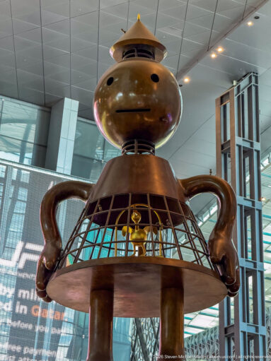 Monumental bronze figure from Tom Otterness’s Other Worlds installation inside Hamad International Airport.