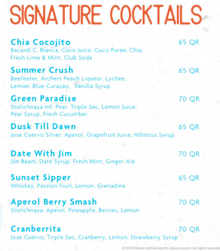 Close view of a cocktail menu listing mixed drinks and prices in QR, including Summer Crush and Green Paradise.