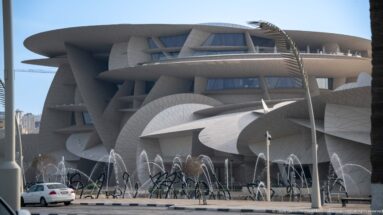 National Museum of Qatar with overlapping pale disc-like forms and fountains in the foreground.
