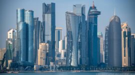 Telephoto view of Doha’s West Bay skyline with tightly grouped glass, steel, and stone high-rise towers.