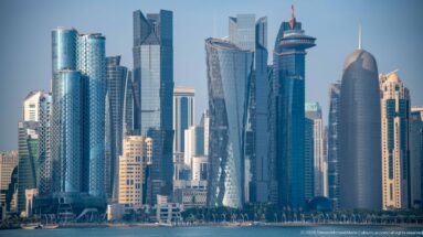 Telephoto view of Doha’s West Bay skyline with tightly grouped glass, steel, and stone high-rise towers.