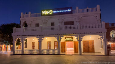 Novo Cinemas sign crowns a white traditional-style building with balconies and a marked cinema entrance.