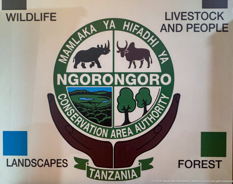 Large Ngorongoro Conservation Area Authority emblem with animal, landscape, and tree symbols beside thematic labels.