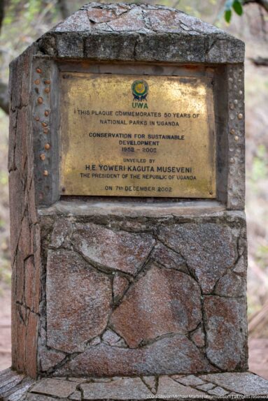 Brass plaque in a stone pedestal commemorating fifty years of Uganda national parks, 1952–2002.