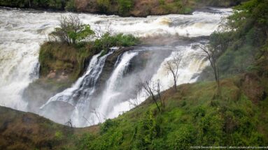 Oblique view of a side cascade, upper rapids, and green slopes at Murchison Falls.