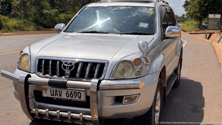 Silver Toyota Land Cruiser with bull bar parked beside the road near Murchison Falls National Park.