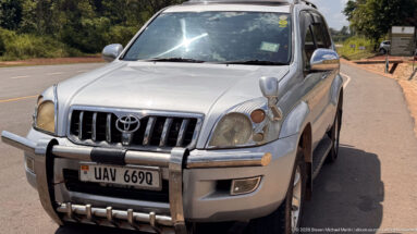 Silver Toyota Land Cruiser with bull bar parked beside the road near Murchison Falls National Park.