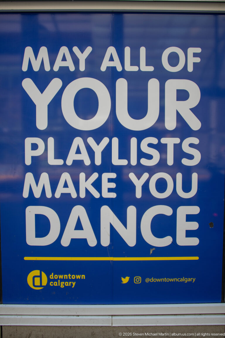 Blue Downtown Calgary poster with large white text reading, Play all of your playlists. Make you dance.