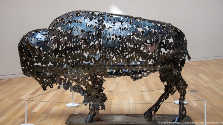 Lionel Peyachew’s Education is the New Buffalo, a life-size bison sculpture constructed from dark metal letters.