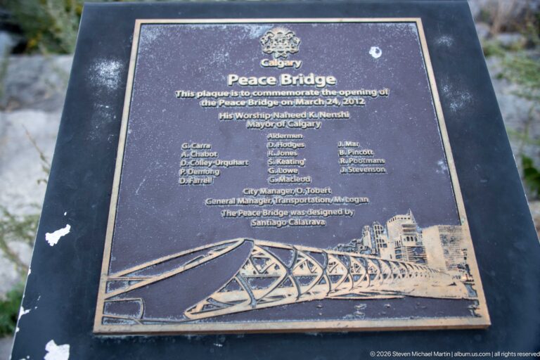 Bronze Calgary Peace Bridge opening plaque dated March 24, 2012, with names and a bridge illustration.