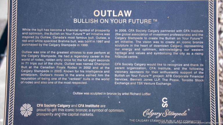Interpretive plaque titled Outlaw — Bullish on Your Future describing a Calgary Stampede bronze sculpture and artist Richard Loffler.