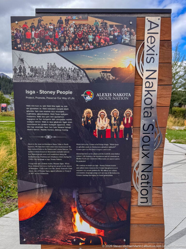 Alexis Nakota Sioux Nation interpretive panel with historical photographs, cultural portraits, text, and a campfire image.