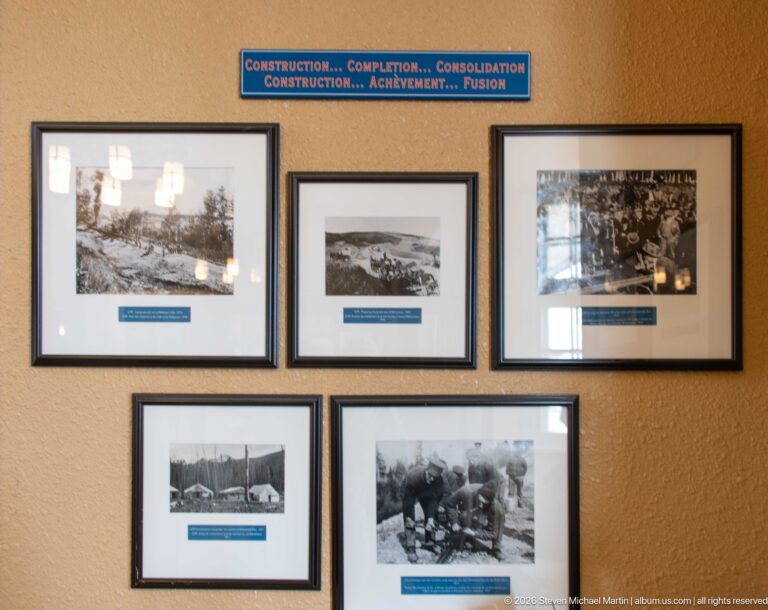 Five framed historic photographs beneath a bilingual Construction, Completion, Consolidation heading at Jasper railway station.